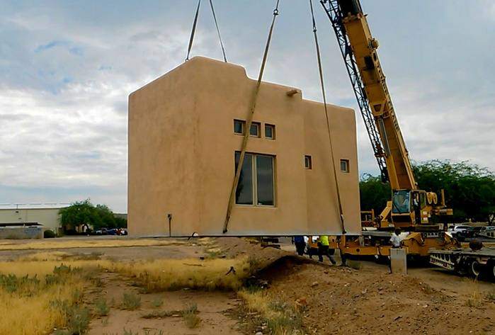 Finished stucco ADU being craned into place