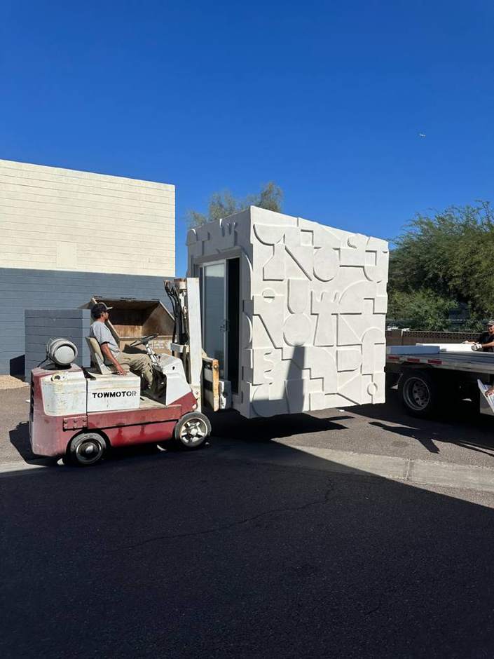 Sculpted office pod being moved by forklift