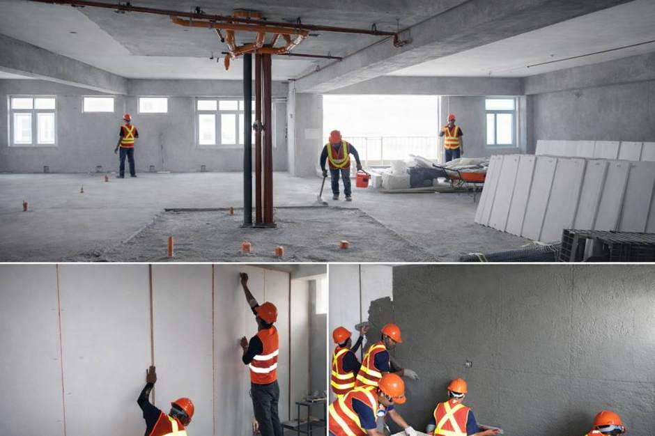 Crews setting and coating partition walls